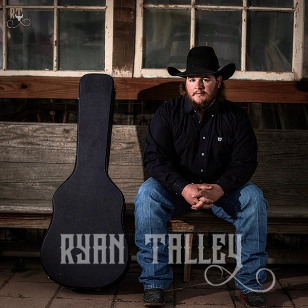 Ryan Talley, Texas country music singer-songwriter, performing live on stage with acoustic guitar. a professional country band for hire.